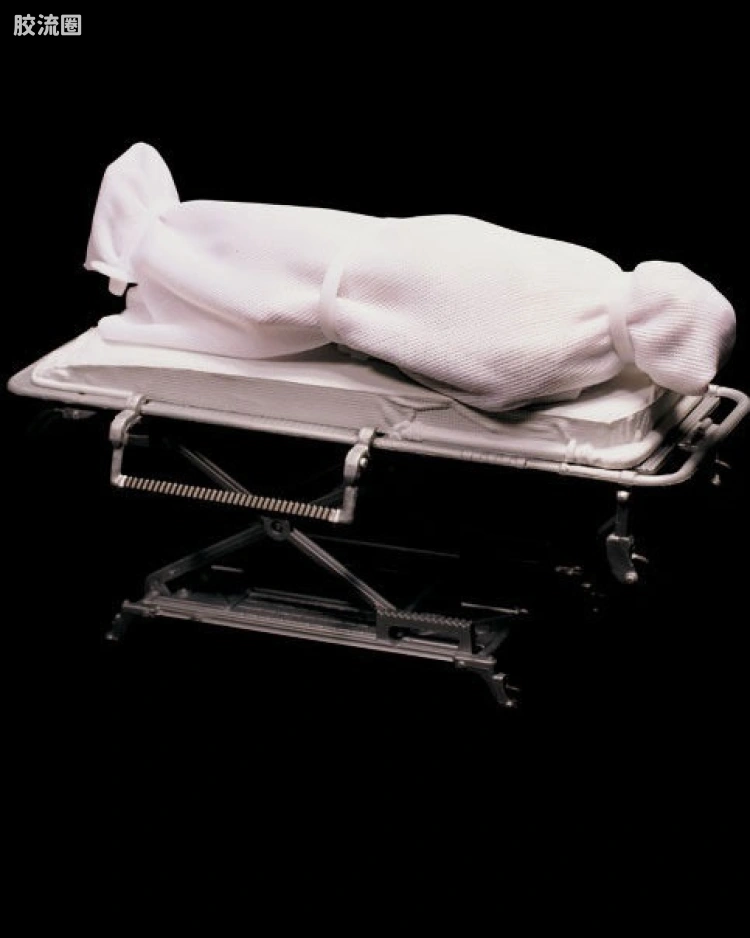 VICTIM IN BODY BAG AND GURNEY